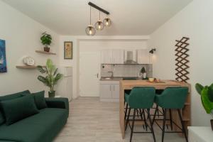 a kitchen and living room with a couch and a table at Piazza dei Signori in Zadar