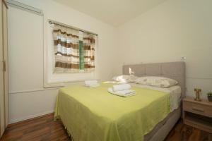 a bedroom with a bed with two towels on it at Piazza dei Signori in Zadar
