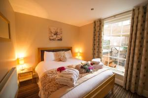 a bedroom with a bed with towels on it at Chester Apartments in Chester