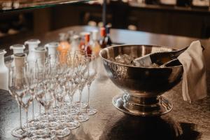 a group of wine glasses on a counter with a bowl at Hotel Berghof - St Johann in Salzburg in Sankt Johann im Pongau +189 photos