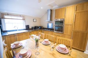 a kitchen with a table with plates and glasses on it at Chester Apartments in Chester