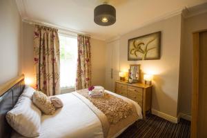 a bedroom with a bed and a window at Chester Apartments in Chester