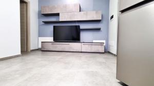 a living room with a flat screen tv on a wall at Residence Parco Castello 2 in Novi Ligure