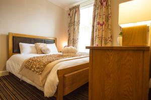 a bedroom with a bed and a window with curtains at Chester Apartments in Chester