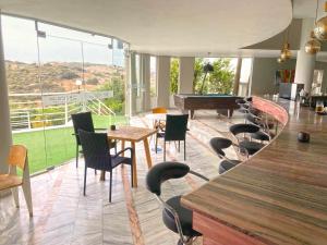 a room with tables and chairs and a pool table at Pelagia Bay Hotel in Agia Pelagia