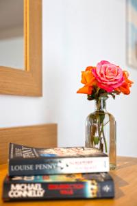 a vase with a flower on top of a stack of books at Pelagia Bay Hotel in Agia Pelagia