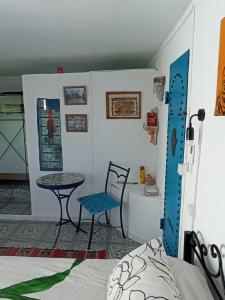 a room with a bed and a table and a chair at Dar Warda in Bizerte
