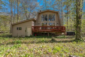 a small house with a deck in the woods at Sugarloaf Chalet 3BDR Garden View at Cedar 2510 in Cedar