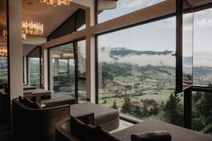 a living room with a view of a mountain at Hotel Berghof - St Johann in Salzburg in Sankt Johann im Pongau
