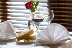 a table with a rose and a glass of wine at The Halliburton in Halifax