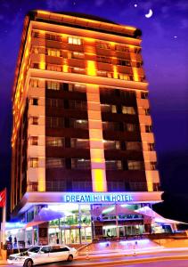 a hotel building with a car parked in front of it at Dream Hill Business Deluxe Hotel Asia in Istanbul