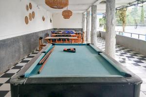 a room with a pool table with bats on it at Pangrango Valley Resort RedPartner in Situ 2