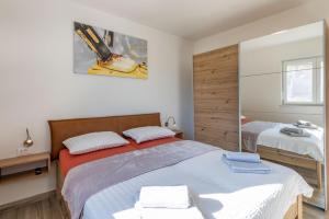 a bedroom with two beds and a mirror at Villa Mia in Labin, a two apartment villa with pool close to the sea in Krapan