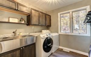a kitchen with a washing machine and a sink at Vista Haven - Mountain Views and Fireplace and Big Screen TVs and Extras in Jasper