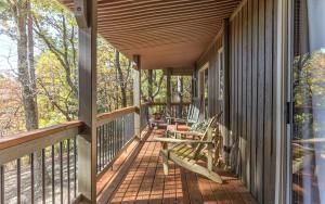 a wooden porch with a table and chairs on it at Vista Haven - Mountain Views and Fireplace and Big Screen TVs and Extras in Jasper