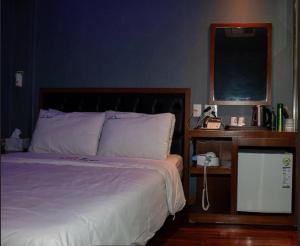 Ένα ή περισσότερα κρεβάτια σε δωμάτιο στο Nidonado Motel