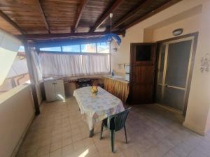 a kitchen with a table with a table cloth on it at A Casa Ma&Mi in Lido di Latina