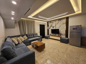 a living room with a blue couch and a television at villa 100C A2 in Sharm El Sheikh