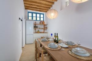 a dining room with a wooden table and chairs at White House 1871 in Lachania