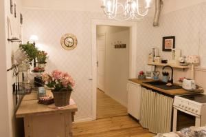 a kitchen with a counter with flowers on it at Villa Tammsaare Deluxe Beach Apartment in Pärnu +2 photos