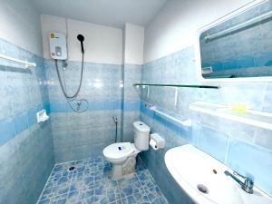 a blue bathroom with a toilet and a sink at Patong Canal Villa R308 in Patong Beach +10 photos