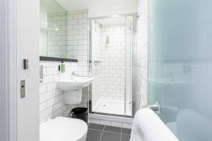 a bathroom with a toilet and a sink and a shower at easyHotel Newcastle in Newcastle upon Tyne