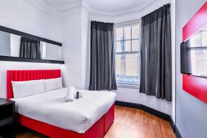 a hotel room with a large bed and a window at easyHotel Newcastle in Newcastle upon Tyne
