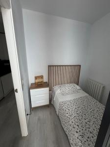 a bedroom with a bed and a nightstand with a box on it at El Balcón de la Nubla in Cazorla +7 photos