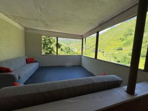 a room with a couch and a large window at Zirve Apart in Uzungöl