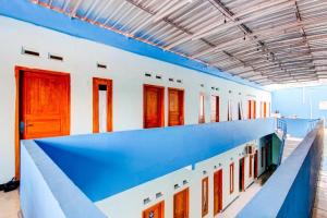 a row of doors and windows in a building at Hotel O Gioba Kost Syariah in Grobogan