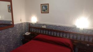 A bed or beds in a room at Pensión Campoy