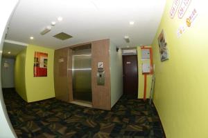 a hallway of an office building with a elevator at Sunshine Inn in Bintulu