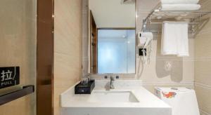 a bathroom with a white sink and a mirror at Yimi Hotel Guangzhou Yuexiu Park North Branch in Guangzhou +77 photos