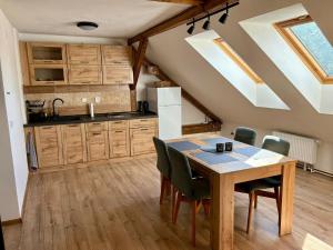 a kitchen with a table and chairs in a room at Ubytování v soukromí U Aničky in Blatná