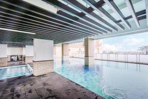 basen z niebieską wodą w budynku w obiekcie Super OYO Capital O 483 Tamansari Panoramic Bandung w mieście Bandung