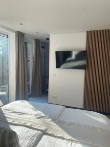 Un dormitorio con una cama y un televisor en una pared. en Aan de Plenkert, en Valkenburg 4 fotos más