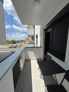 a balcony with a table and chairs on a building at Apartman Bella Brčko in Brčko +6 photos