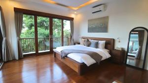 a bedroom with a large bed and a balcony at SummerVille Nusa Dua by REJA Villas in Nusa Dua +40 photos
