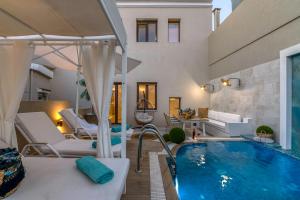 a living room with a swimming pool and a house at Kallisti Palace - Private Pool with Hydromassage in Kissamos