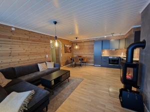 a living room with a couch and a stove at Apartment in Voss - Tråstølen in Skulestadmo