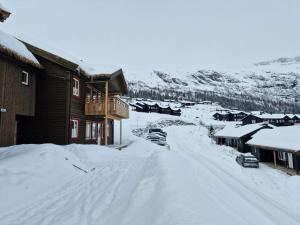 a group of houses in a snow covered town at Apartment in Voss - Tråstølen in Skulestadmo