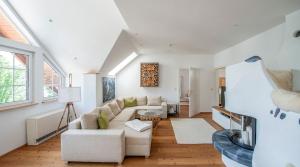 a living room with a couch and a table at SeeAtelier Grundlsee - Your Austrian Home in Grundlsee