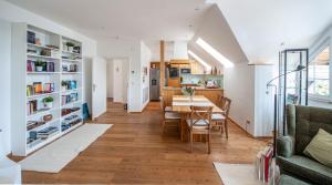 a living room and dining room with a table and chairs at SeeAtelier Grundlsee - Your Austrian Home in Grundlsee