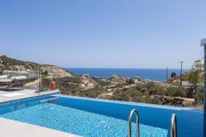 a swimming pool with a view of the ocean at Royal Garden Villas in Balíon