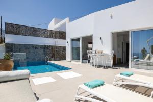 a villa with a swimming pool and a patio at Royal Garden Villas in Balíon +121 photos