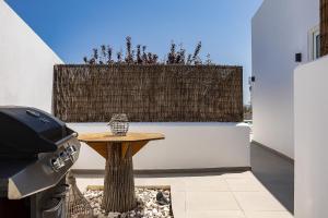 a patio with a wooden table and a fence at Royal Garden Villas in Balíon +122 photos