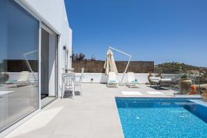 a swimming pool on the roof of a house at Royal Garden Villas in Balíon