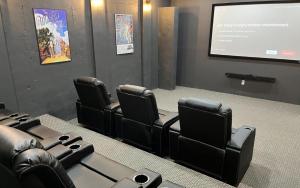 a room with leather chairs and a projection screen at McElroy Manor - Luxury and comfort in Big Canoe in Jasper