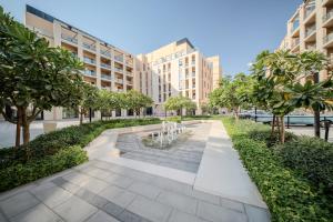 an image of a garden with trees and buildings at The Cloud 9 Penthouse by Blue Cloud Holidays in Sharjah Intl
