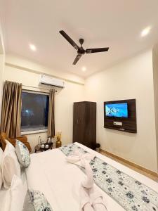 a bedroom with a bed and a flat screen tv at Hotel Kings Inn in Jaipur